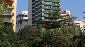 A tall, modern building with multiple balconies and a clear blue sky in the background. - Baywatch Tower (Manila)