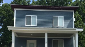 A two-story house with a front porch, a door, and a number '22' on the wall. - 1st Class Rentals Munson Manor IV  at Columbia Street (Oneonta)
