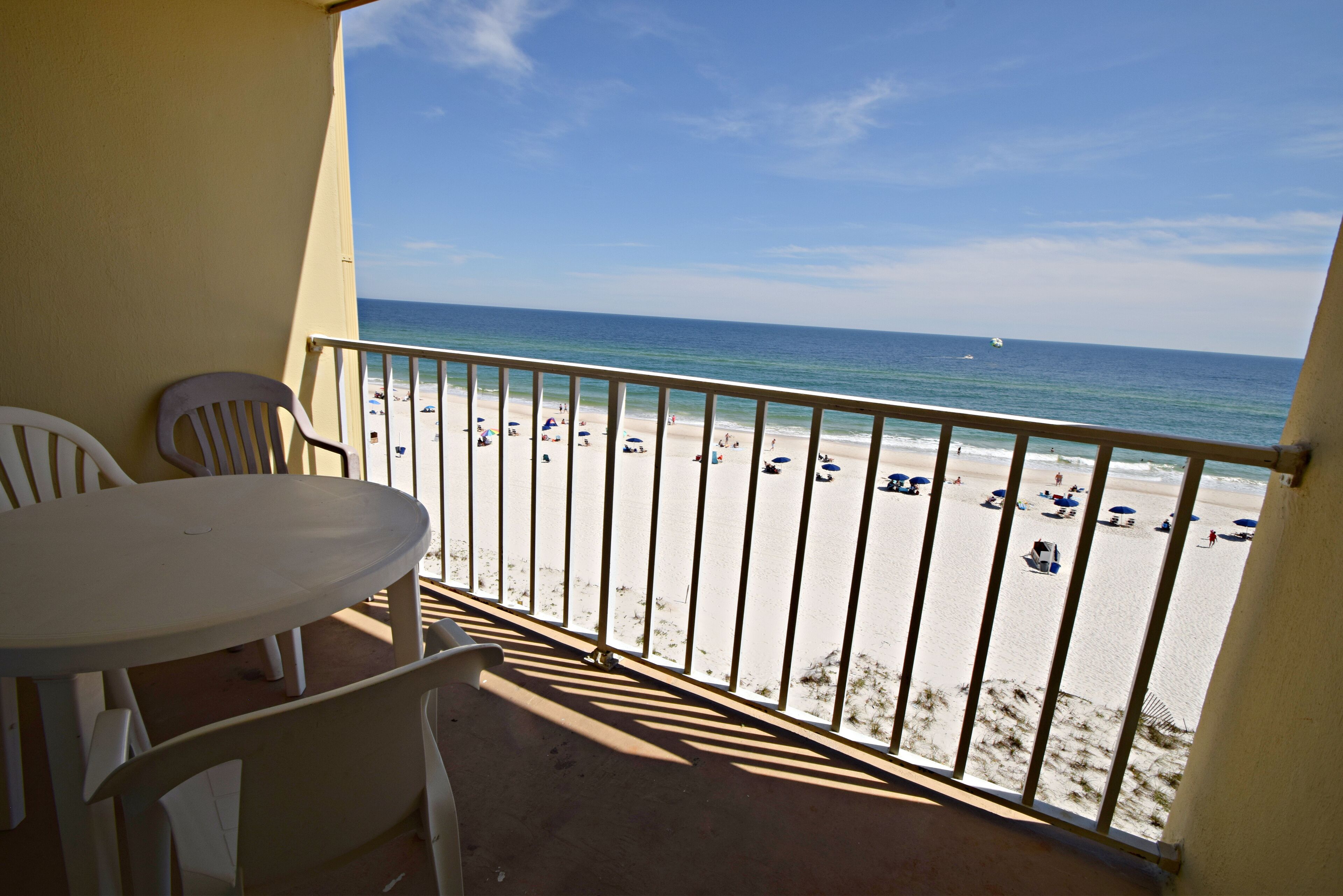 A balcony with a view of a beach.