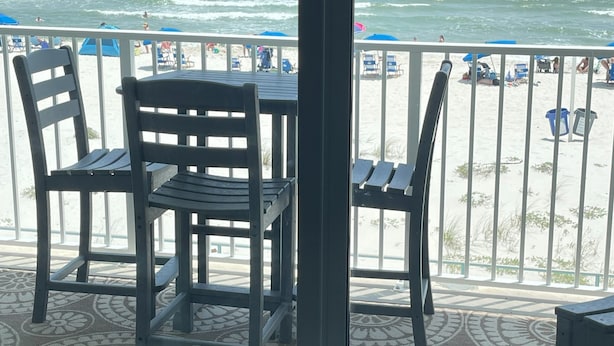 Een balkon met uitzicht op het strand en de oceaan.