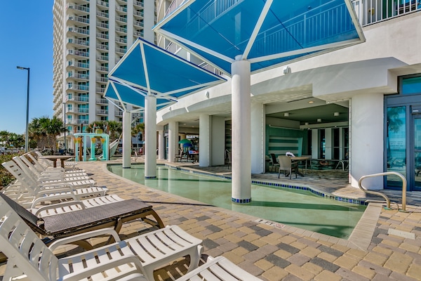 Resort pool with cabanas, comfy loungers, and a vibrant, relaxing setting