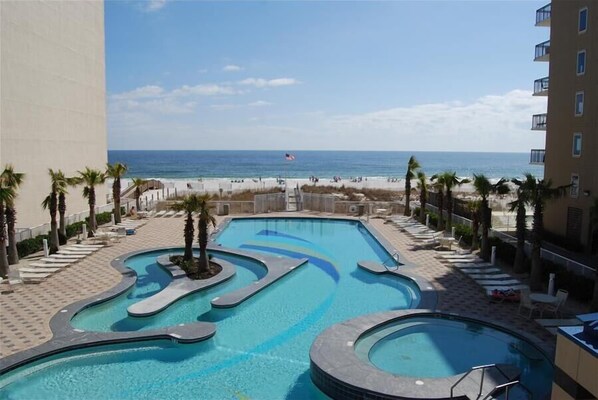 Relax by the pool, surrounded by palm trees and stunning ocean views.