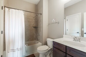A bathroom with a bathtub, toilet, and sink. - Indulge in Relaxation:King Bed Suite with Park Access for Your Ultimate Getaway! (Nashville)