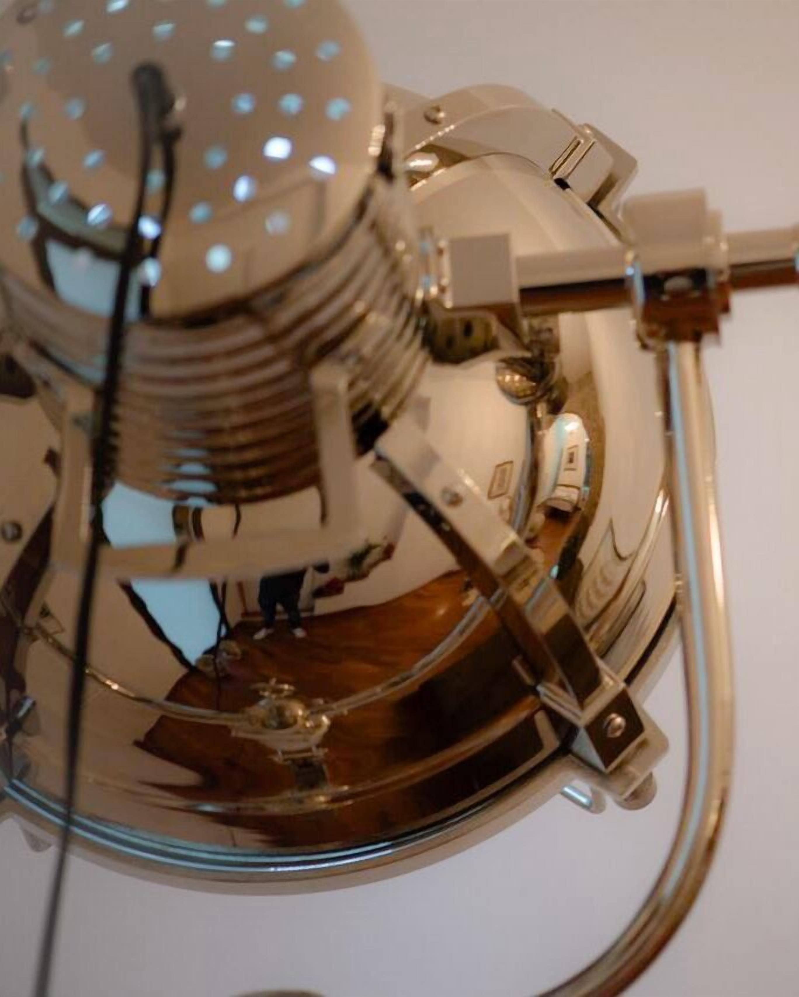 A mechanical device with metallic components and a circular base, possibly a piece of machinery or equipment.