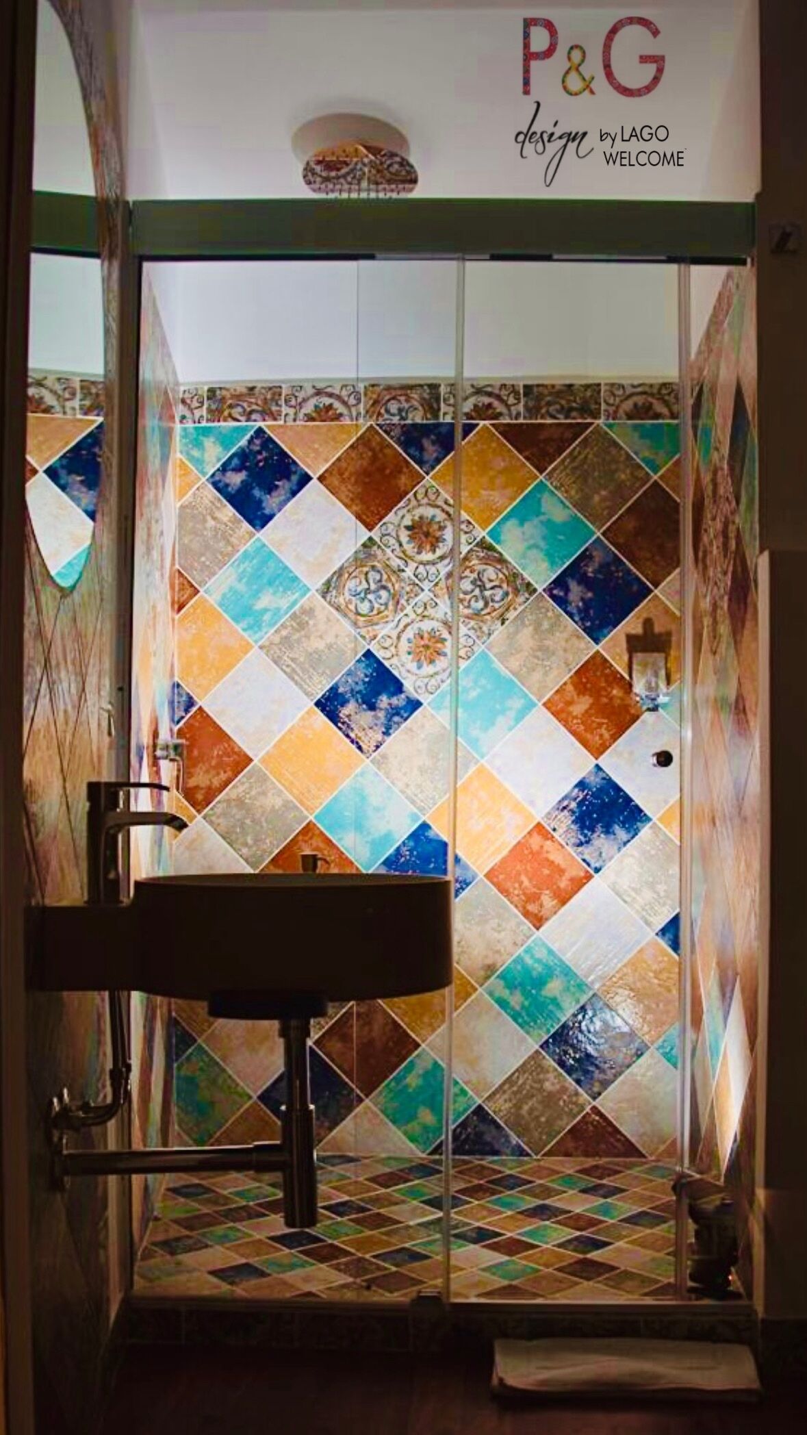 A bathroom with a colorful mosaic tile wall and a sink.