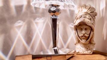 A table with a crystal lamp and a decorative object.