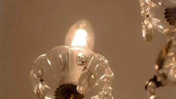 A close-up of a decorative glass structure with a warm light source.