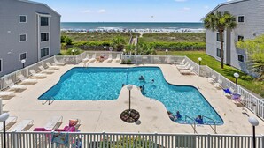 A swimming pool with lounge chairs and a view of the beach. - Sea Cloisters II Ocean Front Beach Retreat (North Myrtle Beach)