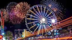 A Ferris wheel with a sign reading "Joe's White House" and fireworks in the background. - Tilghman Lakes By the Sea (North Myrtle Beach)