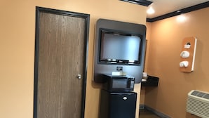 A self-service kiosk with a television, a beverage dispenser, and a small refrigerator. - El Rancho Motel (Los Angeles)