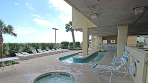 A pool area with lounge chairs and a hot tub. - Sunrise Pointe Oceanfront Resort (North Myrtle Beach)