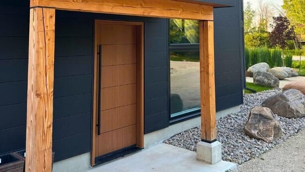 A modern two-story house with a dark exterior, large windows, and a wooden porch. - Indoor Pool & Hot Tub, Steps to Ski Lift (Blue Mountains)