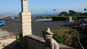A parking area with a view of the ocean, a statue, and a blue car. - Dana Point Dream Home with White Water Ocean View (Permit #STR14-0084) (Dana Point)