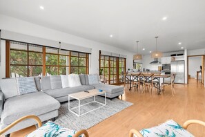 Relax in this spacious living area with a sofa, dining table, and kitchen.