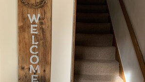 A wooden welcome sign with the word "WELCOME" on a staircase. - Character Cottage in Haworth. Come and Enjoy Yorkshire...Yours To Discover! (Haworth)
