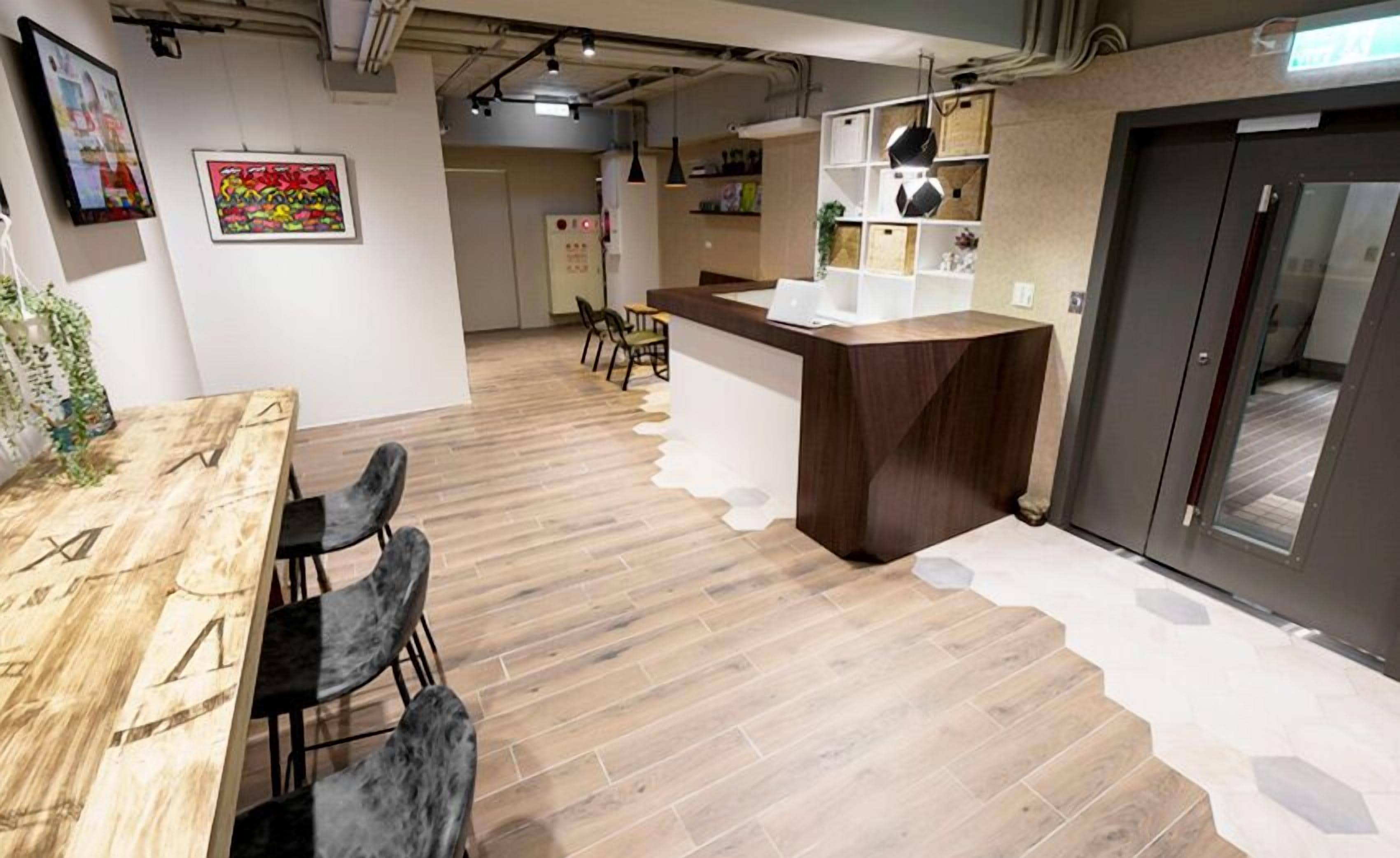A modern kitchen with a wooden countertop, a built-in oven, and a refrigerator.