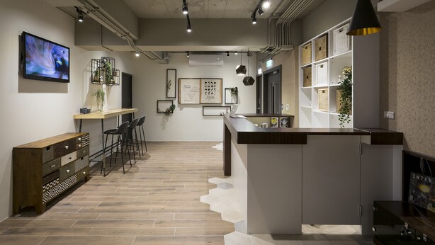 A modern kitchen with a central island, bar stools, and a large TV on the wall. - 109 Hostel Taipei (Taipei)