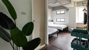 A room with two beds, a window, a plant, and a green cart. - 109 Hostel Taipei (Taipei)