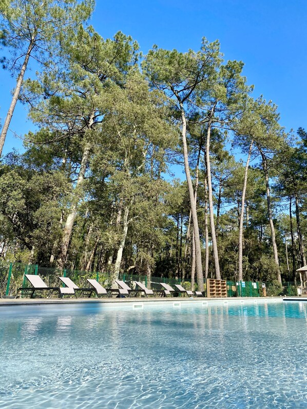 Outdoor pool, open 10 AM to 6 PM, pool umbrellas, pool loungers