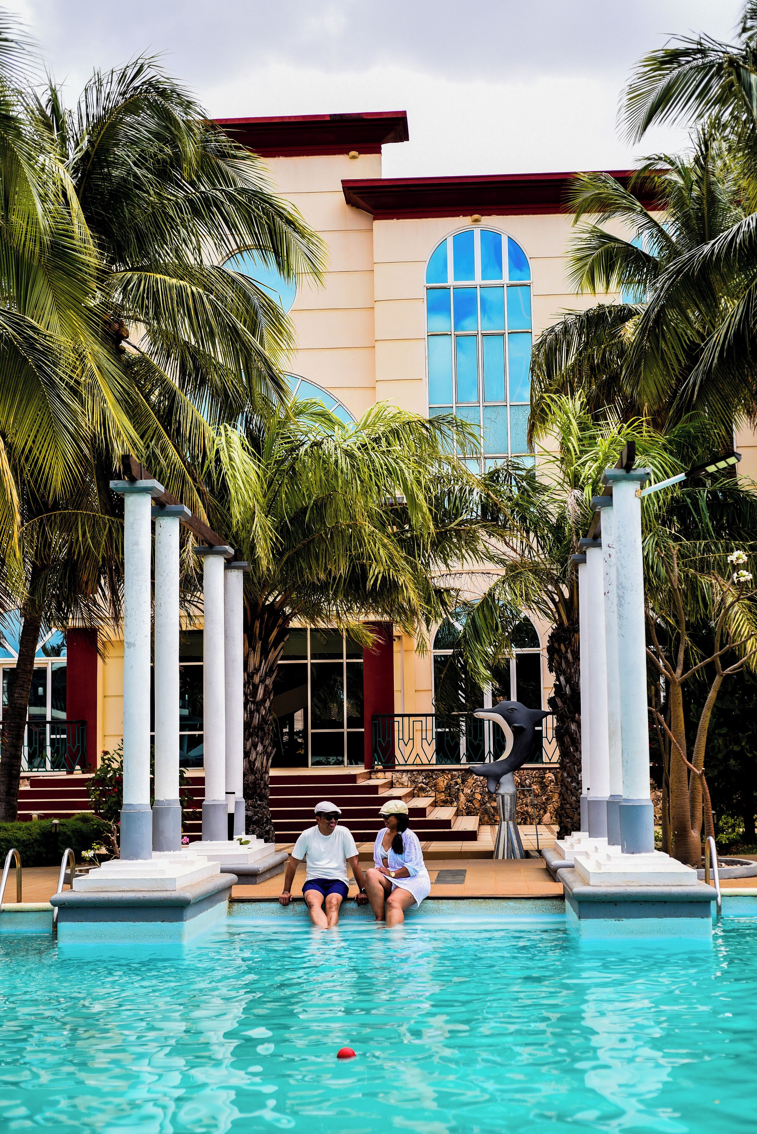 Een buitenzwembad, ligstoelen bij het zwembad