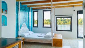 A room with a bed, a wooden bench, and large windows overlooking a lake. - ArkaBarka Floating Hostel and Apartments (Belgrade)