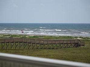 A wooden pier extending into the ocean with waves crashing against it. - Knot 4 Sail -Beach Front- Ocean Views- Front Row - 2BD/2BA. Sleeps 6 (Galveston)