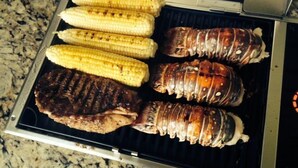A grill with grilled corn, steak, and lobster on a kitchen counter. - Knot 4 Sail -Beach Front- Ocean Views- Front Row - 2BD/2BA. Sleeps 6 (Galveston)