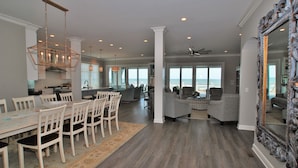 A spacious living area with a dining table, chairs, and a large mirror. - OCEANFRONT / Sleeps 16 / BELLA VISTA / POOL / SPA / ELEVATOR / ELEGANT HOME (Isle of Palms)
