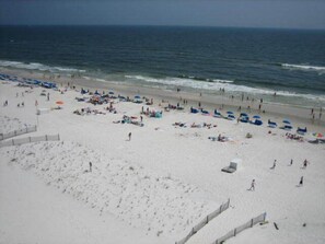 A beach with umbrellas and people.