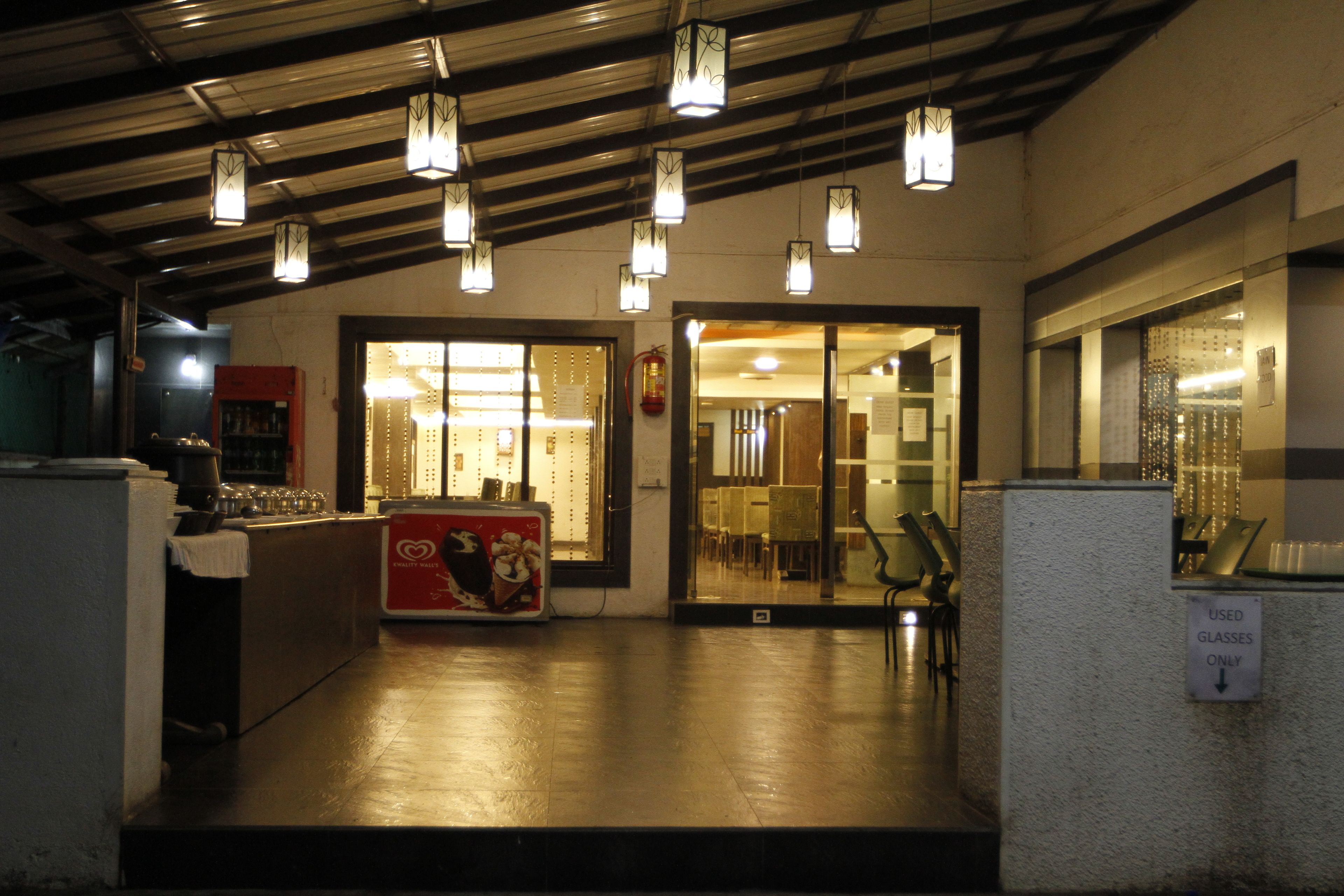 An interior with a reception desk, a counter with a red sign, and a sign indicating 'used glasses only'.