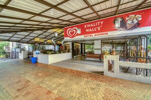 A covered outdoor area with a sign for 'Kwality Wall's Hotel Ashwin'. - Hotel Ashwin Igatpuri, Pure Veg & Jain Food  (Igatpuri)