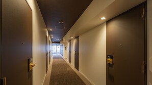A hotel hallway with doors numbered 604 and 603, carpeted floors, and recessed lighting. - The OneFive Tokyo Shibuya (Tokyo)