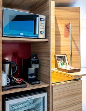 Enjoy a convenient kitchenette with a microwave, coffee machine, and mini refrigerator.