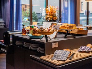 A breakfast buffet with pastries, a fruit display, and a coffee station. - Novotel Suites Colmar Centre (Colmar)