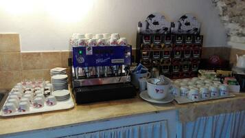 A coffee station with a coffee machine, cups, and various coffee products.