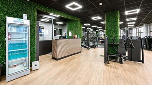 A gym with exercise equipment, a reception desk, and a vending machine. - Grand Hotel Velingrad (Velingrad)