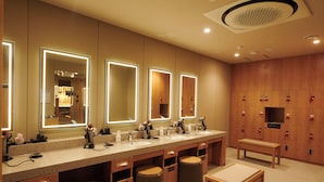 A hotel bathroom with a long vanity, multiple mirrors, and a bench. - Dormyinn EXPRESS SEOUL Insadong (Seoul)