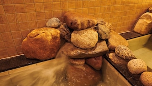 A stone waterfall feature in a bathroom with wooden tiled walls. - Dormyinn EXPRESS SEOUL Insadong (Seoul)
