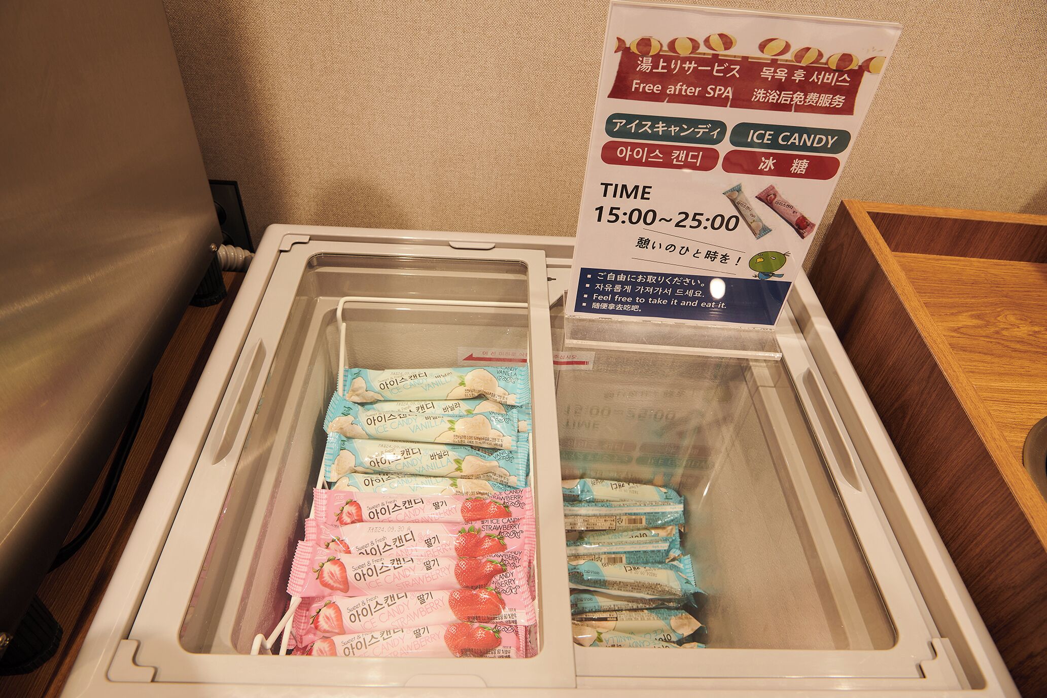A freezer with ice cream packages and a sign indicating free after SPA services.