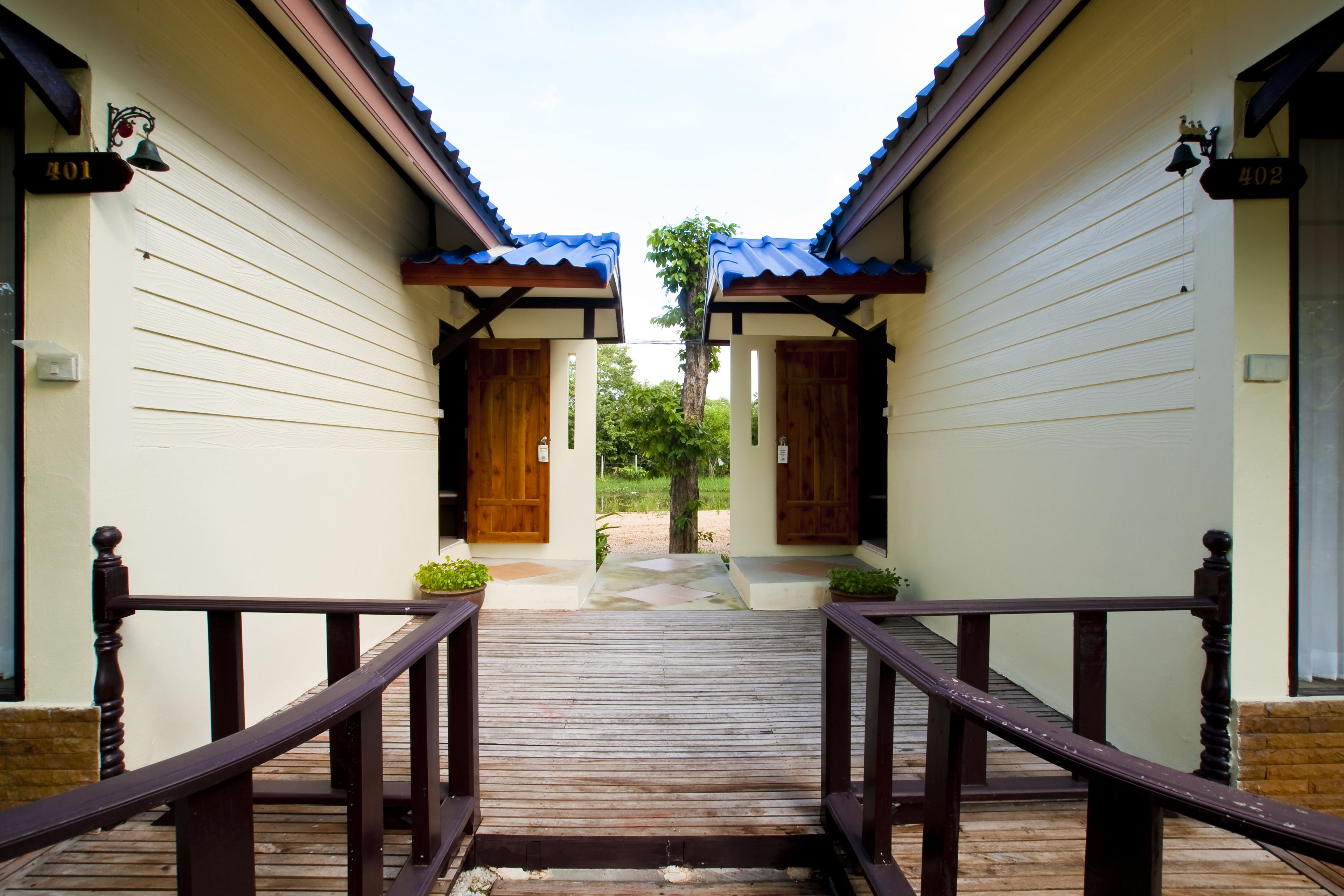 A wooden staircase leading to a building with two doors, each marked with a number.