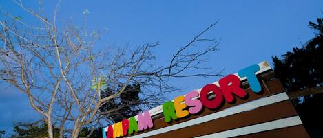 A sign for "INDIAN RESORT" with a striped background and colorful lettering.