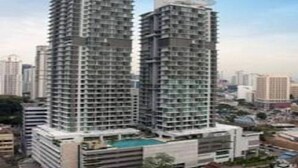 A high-rise building with multiple balconies and a rooftop pool. - Vinos Asia at Swiss Garden (Kuala Lumpur)