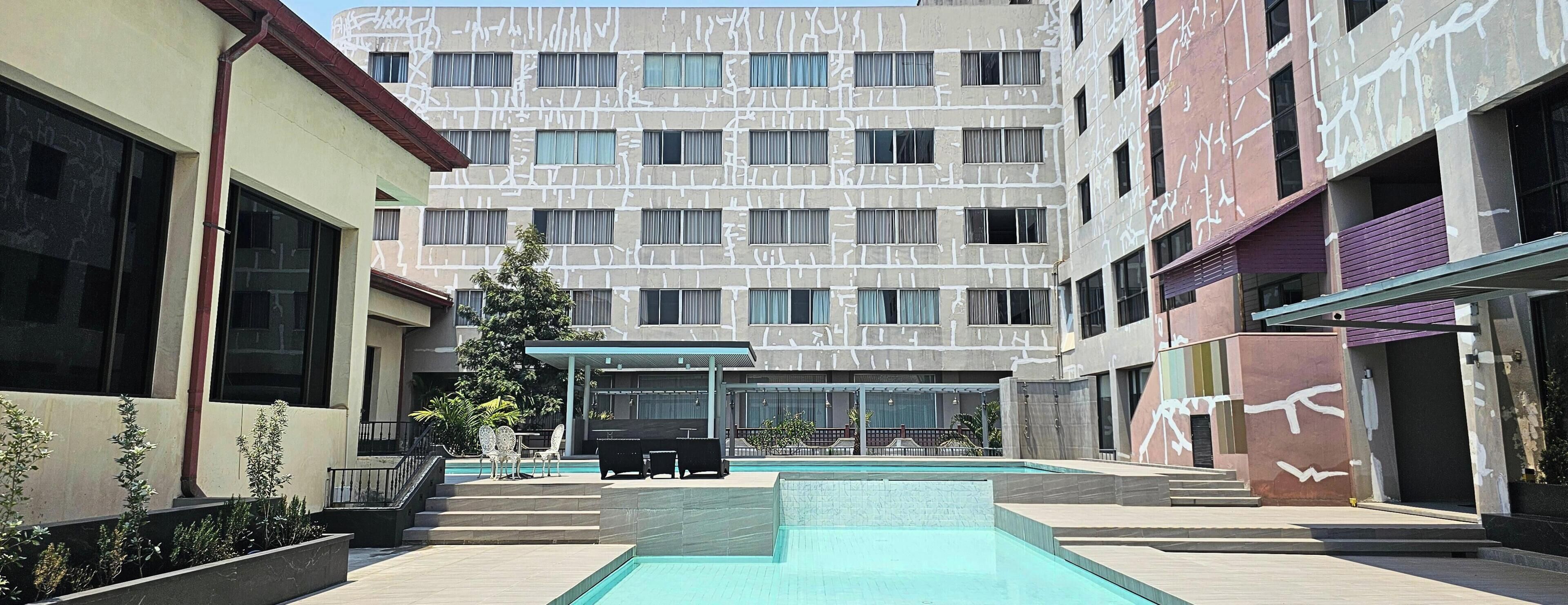Outdoor pool, open 7:00 AM to 7:00 PM, pool loungers