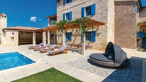 A stone villa with a swimming pool, sun loungers, and a covered seating area. - Beautiful home in Bokordici (Bokordici)