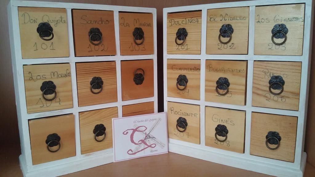 A display of wooden nameplates with numbers and names, each with a metal ring.