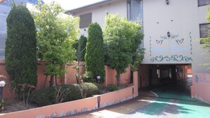 A hotel entrance with a sign reading "Hotel Essor" and a pathway leading to the entrance. - HOTEL ESSOR - Adult Only (Nara)