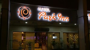 A hotel entrance with a neon sign reading "HOTEL Park Inn." - Hotel Park Inn (Chandigarh)
