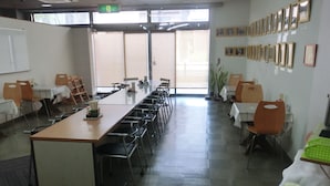 A conference room with a long table, chairs, a whiteboard, and framed pictures on the wall. - Prince Hotel Shimonoseki (Shimonoseki)