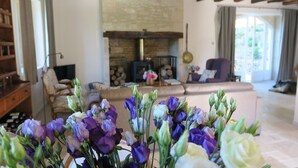 A cozy living room with a fireplace, a sofa, and a bookshelf. - HOUSE OF CEDAR, BEAUTIFUL STONE HOUSE IN DORDOGNE. (Auriac-du-Périgord)
