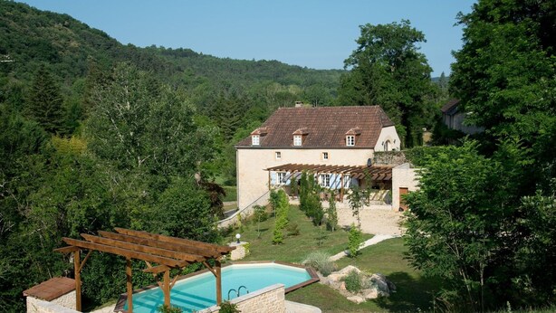 A house with a swimming pool, surrounded by lush greenery and hills. - HOUSE OF CEDAR, BEAUTIFUL STONE HOUSE IN DORDOGNE. (Auriac-du-Périgord)